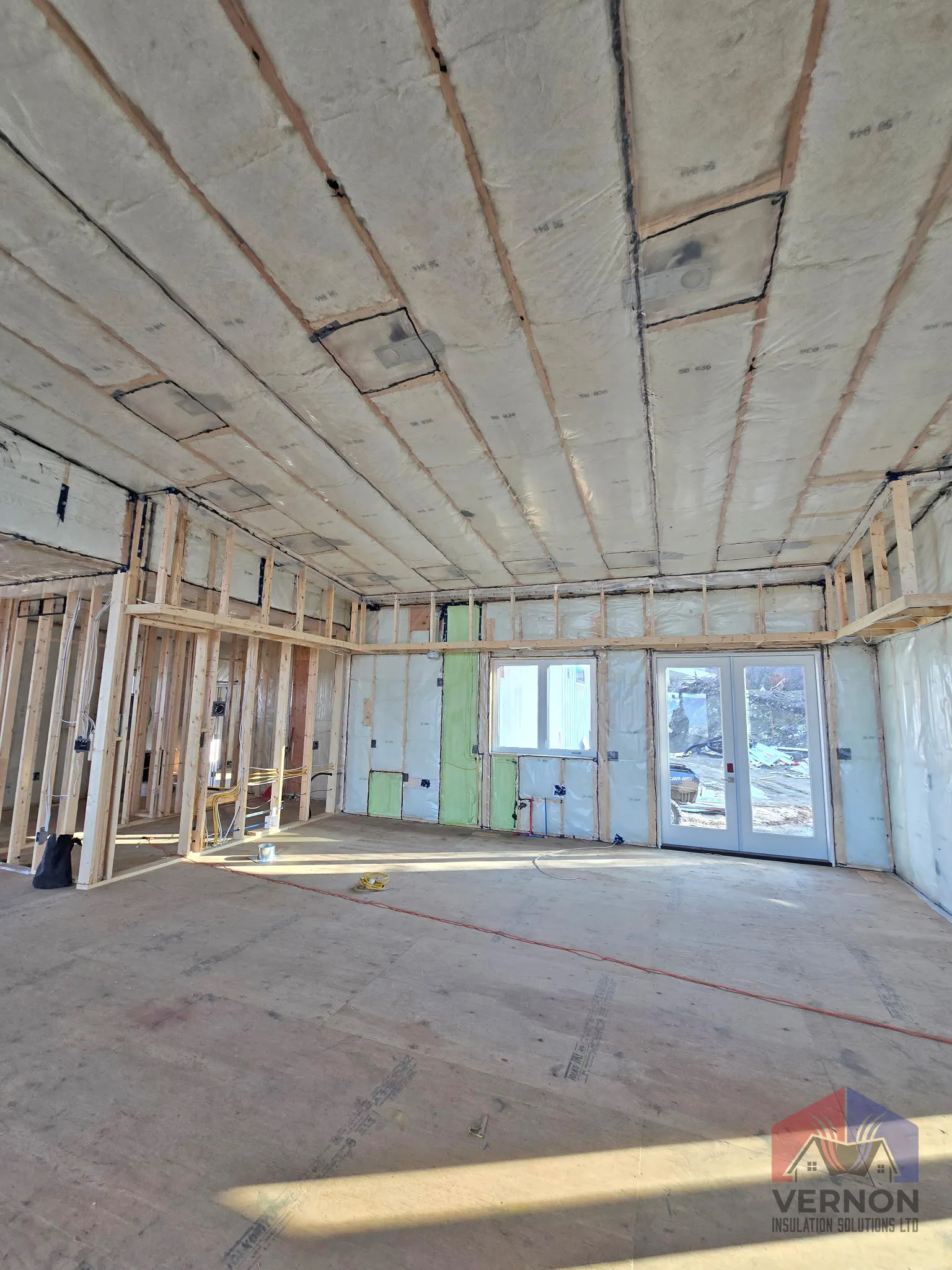 Blown-in and batt insulation in a ceiling assembly