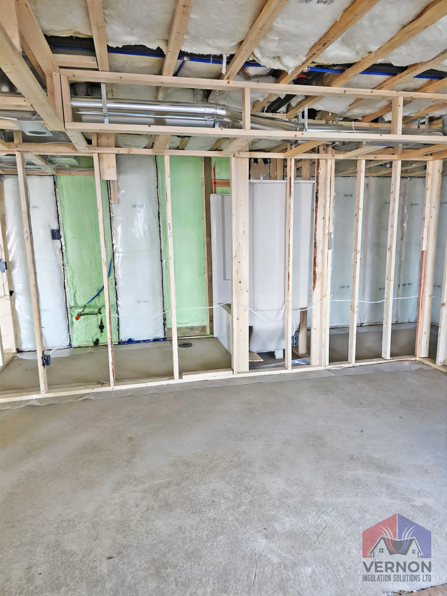 Fiberglass batt insulation installed between wall studs by Vernon Insulation Solutions